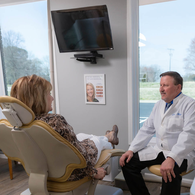 Dr. Hay telling a patient about their sedation options.